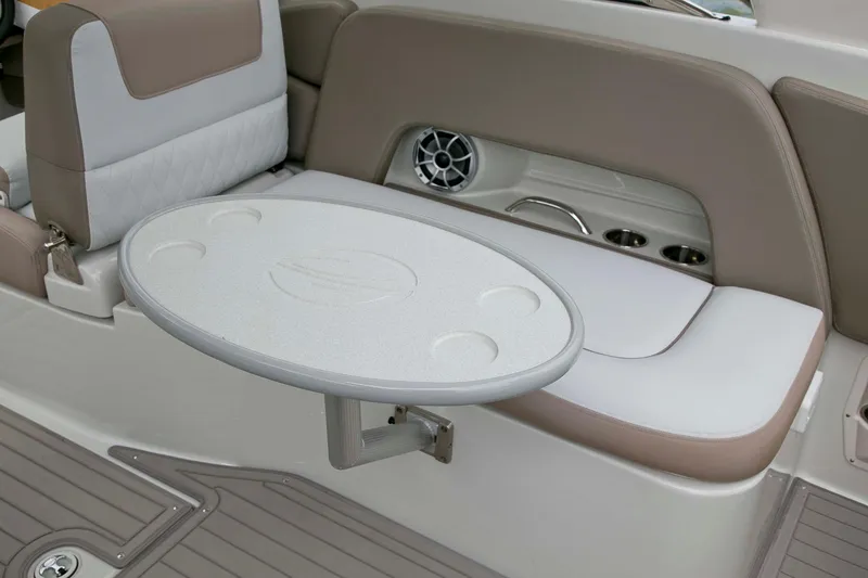 Slide: The Image of 2024 Crownline E305 boat interior with seating and foldable table. - 11