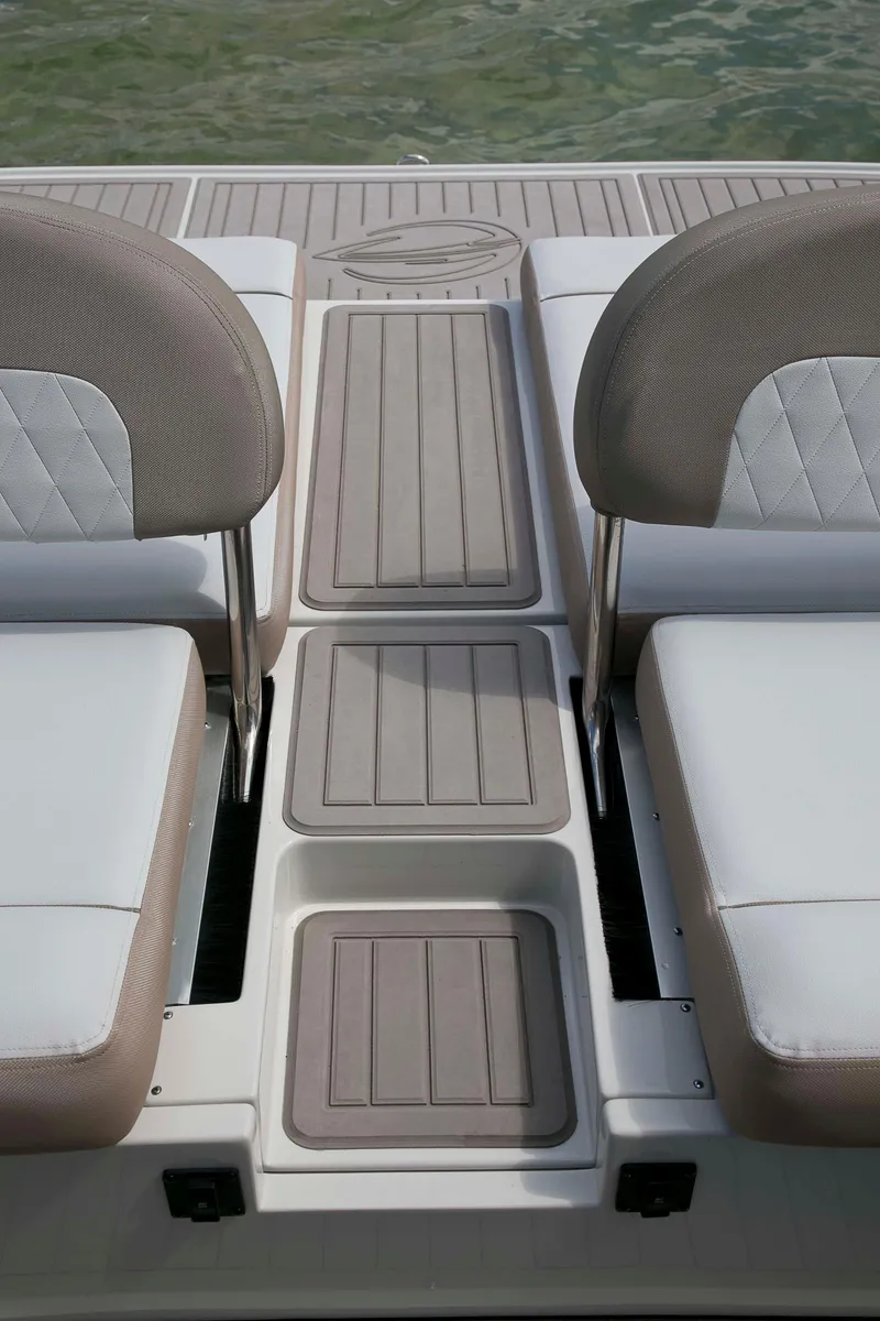 Slide: The Image of 2024 Crownline E305 boat interior with cushioned seating and non-slip flooring. - 12