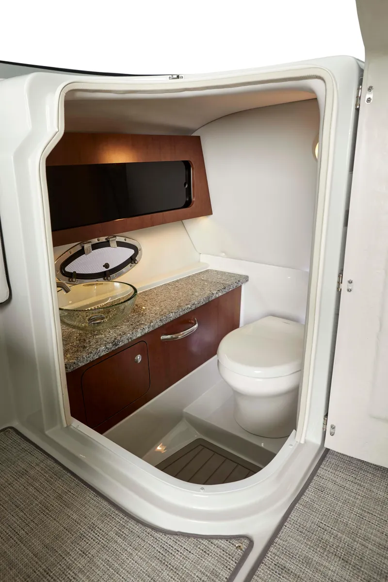 Slide: The Image of 2024 Crownline E305 boat bathroom with modern amenities and sleek design. - 7
