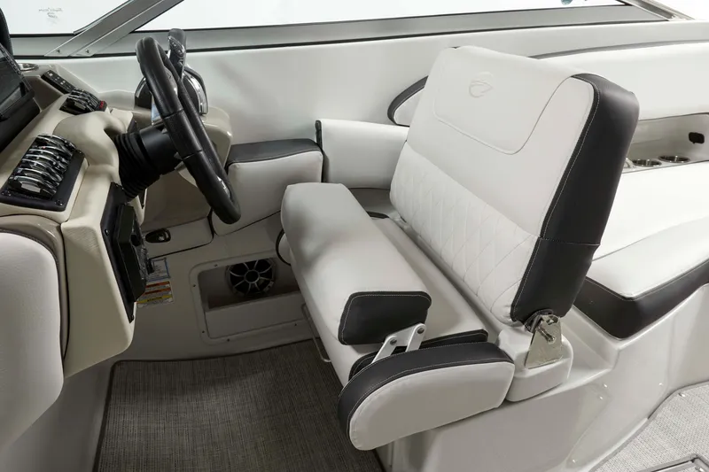Slide: The Image of 2024 Crownline E305 boat interior with steering wheel and cushioned seating. - 9