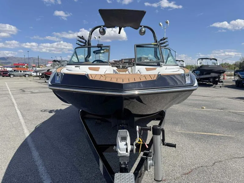 Slide: The Image of 2017 Nautique GS20 boat on trailer under clear blue sky. - 11