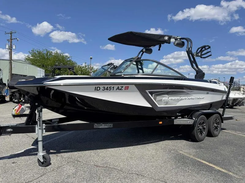 Slide: The Image of 2017 Nautique GS20 boat on trailer under blue sky. - 13