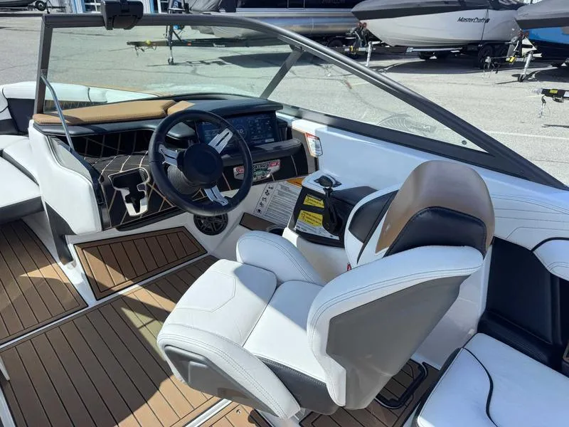 Slide: The Image of 2017 Nautique GS20 boat interior with modern dashboard and white seating. - 2