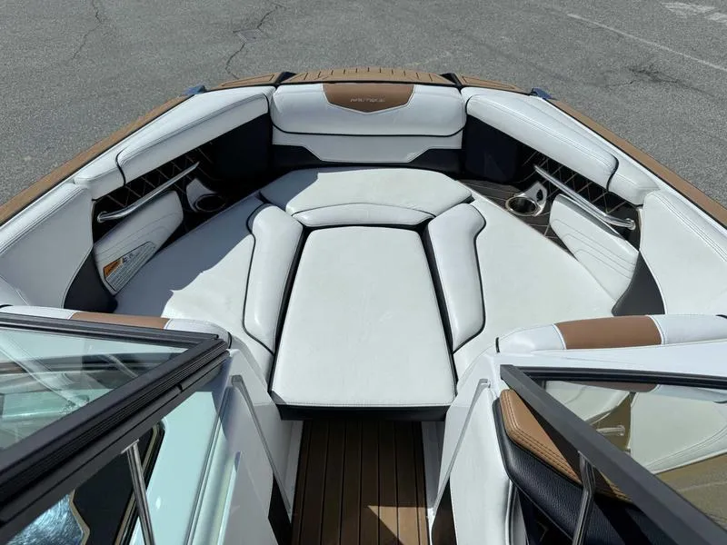 Slide: The Image of 2017 Nautique GS20 boat interior with white and brown seating, open bow design. - 3