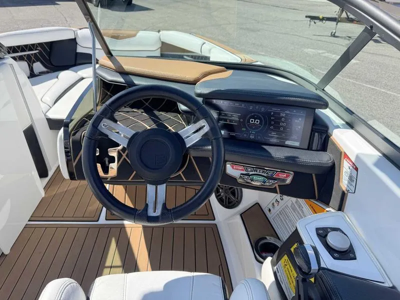 Slide: The Image of 2017 Nautique GS20 boat cockpit with steering wheel and digital dashboard display. - 4