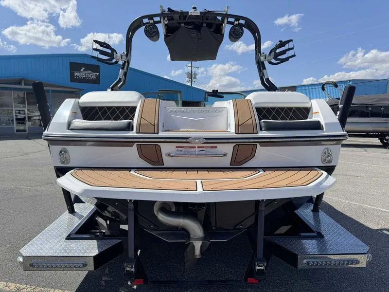 Slide: The Image of 2017 Nautique GS20 boat rear view with teak deck, parked at Prestige dealership. - 6