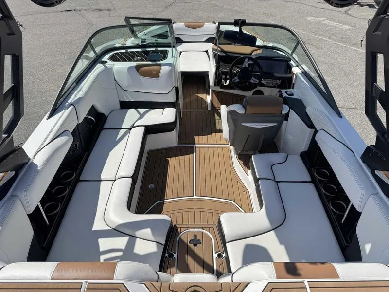 Slide: The Image of 2017 Nautique GS20 boat interior with white and brown seating, sleek design, and modern dashboard. - 7