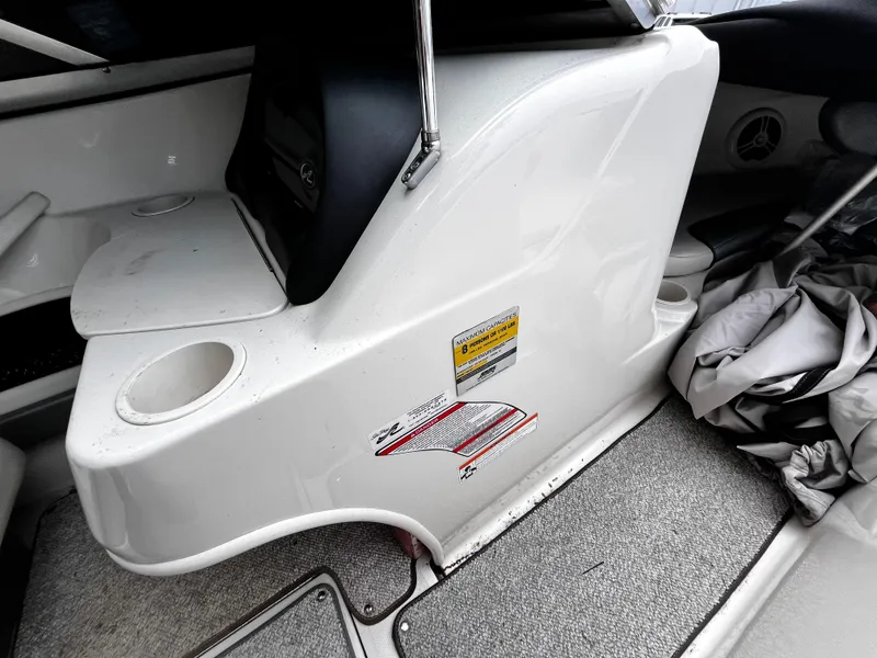 Slide: The Image of 2008 Sea Ray 205 Sport boat interior with cup holders and storage area. - 12