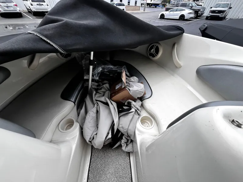 Slide: The Image of 2008 Sea Ray 205 Sport boat interior with cover and miscellaneous items. - 13