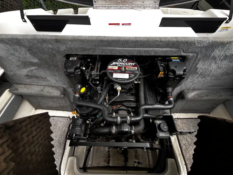 Slide: The Image of Engine compartment of a 2008 Sea Ray 205 Sport boat, featuring a 5.0 Mercury engine. - 14