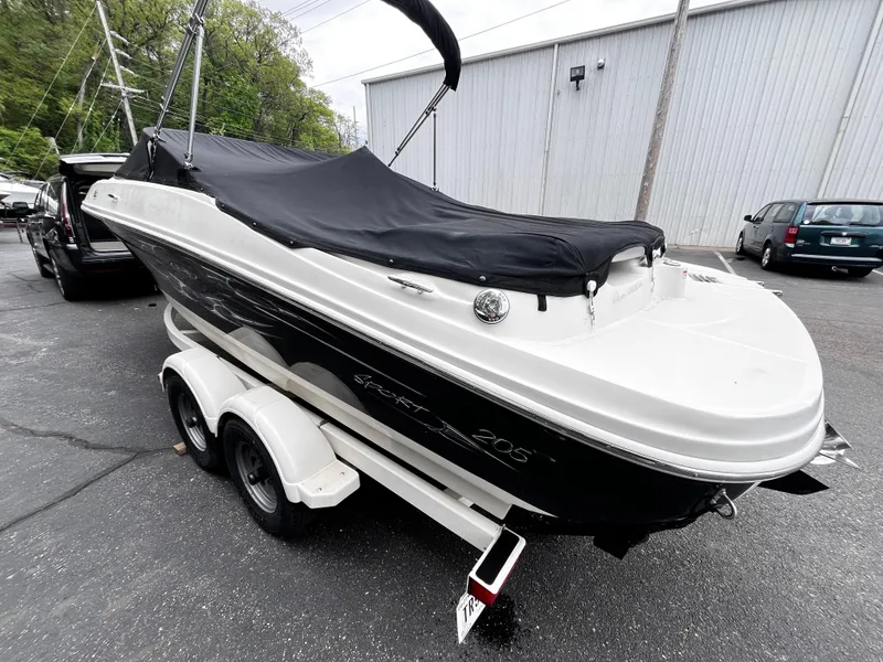 Slide: The Image of 2008 Sea Ray 205 Sport boat on trailer, covered and parked outdoors. - 4