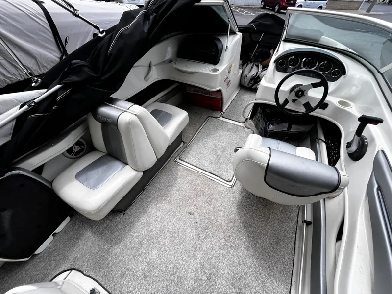 Slide: The Image of 2008 Sea Ray 205 Sport boat interior with seating and steering wheel, featuring a sleek design. - 7
