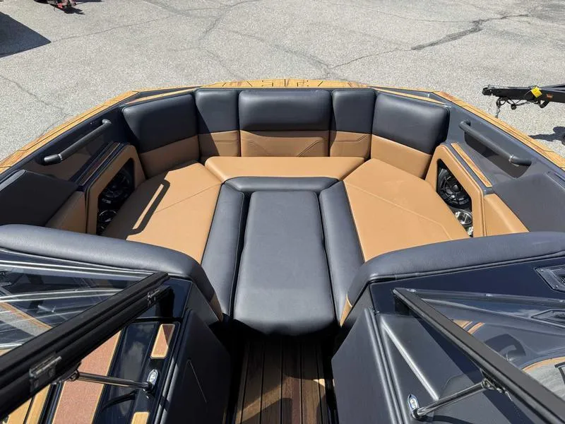 Slide: The Image of 2025 Moomba Max boat interior with tan and gray seating. - 1