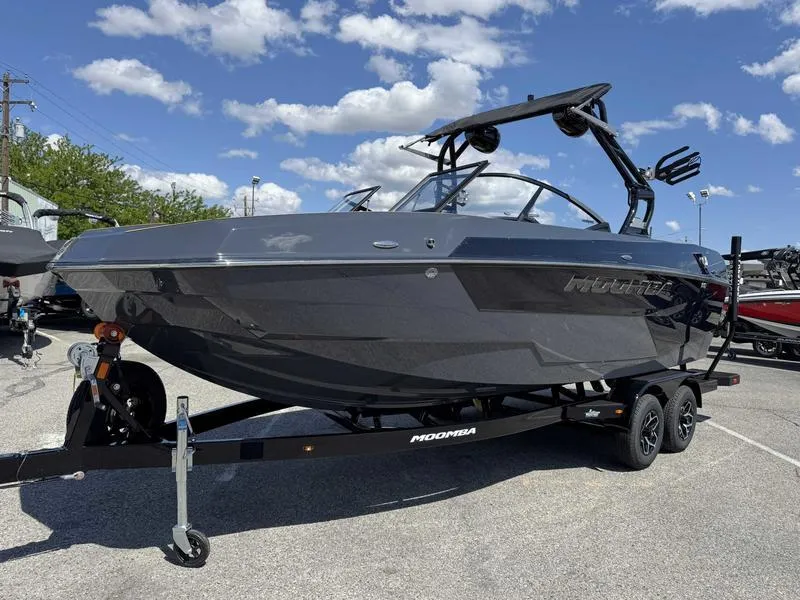 Slide: The Image of 2025 Moomba Max boat on trailer under blue sky with clouds. - 10