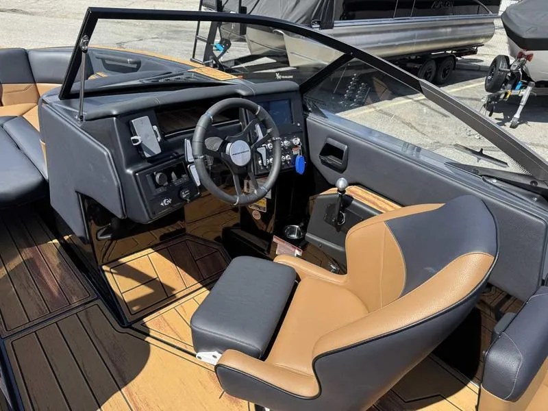 Slide: The Image of 2025 Moomba Max boat interior with modern dashboard and tan seating. - 3