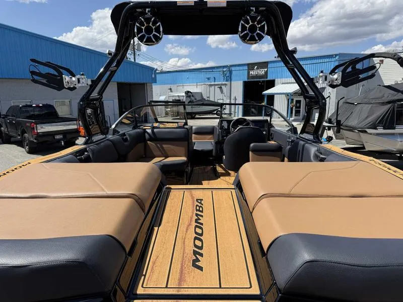 Slide: The Image of 2025 Moomba Max boat interior with tan seating and sleek design. - 7