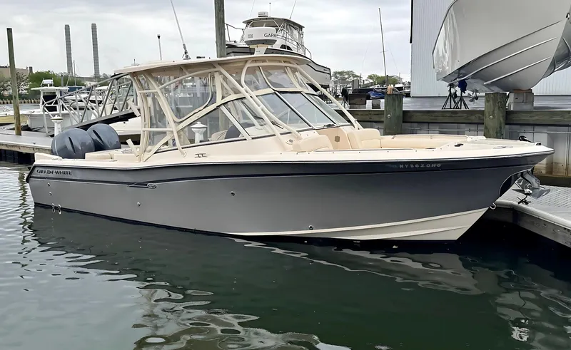 Slide: The Image of 2017 Grady-White Freedom 275 boat docked in marina, featuring dual engines and sleek design. - 0