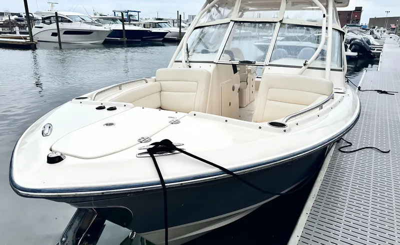 Slide: The Image of 2017 Grady-White Freedom 275 boat docked at marina, featuring sleek design and spacious seating. - 1