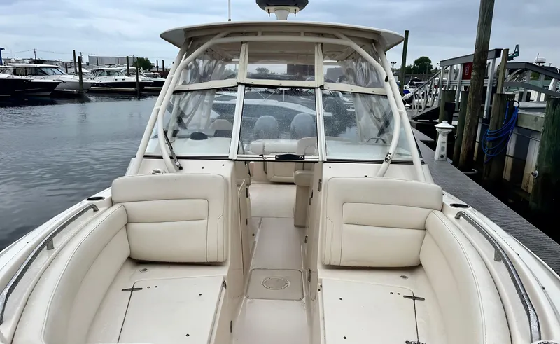 Slide: The Image of 2017 Grady-White Freedom 275 boat docked, featuring spacious seating and sleek design. - 14