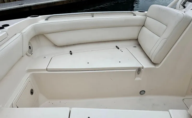 Slide: The Image of 2017 Grady-White Freedom 275 boat interior with white seating and storage compartment. - 15