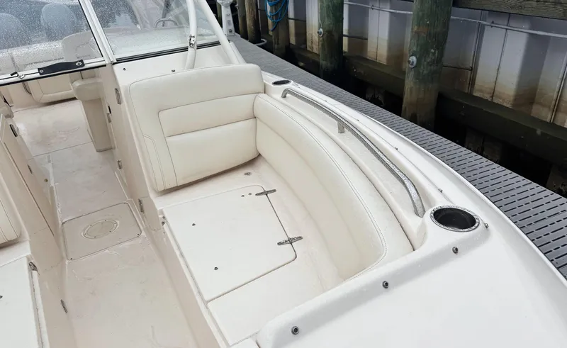 Slide: The Image of 2017 Grady-White Freedom 275 boat interior with white seating and storage compartments. - 16