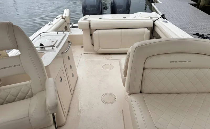 Slide: The Image of 2017 Grady-White Freedom 275 boat interior with beige seating and storage compartments. - 17