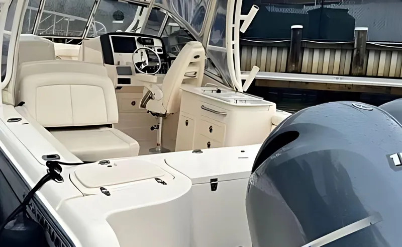 Slide: The Image of 2017 Grady-White Freedom 275 boat interior with seating and controls. - 2