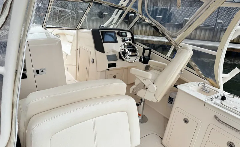 Slide: The Image of 2017 Grady-White Freedom 275 boat interior with helm, seating, and controls. - 3