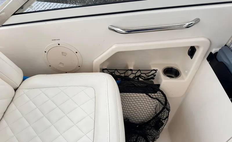 Slide: The Image of 2017 Grady-White Freedom 275 boat interior with white quilted seating and storage net. - 7