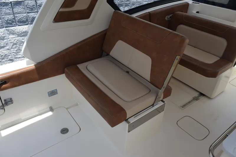Slide: The Image of 2023 Scout 277 Dorado boat interior with brown and beige seating. - 11