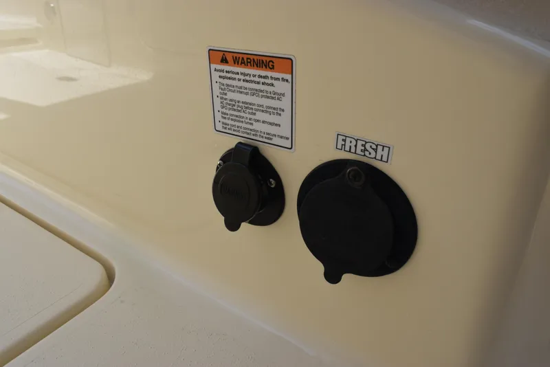 Slide: The Image of 2023 Scout 277 Dorado boat detail with warning label and fresh water access. - 21
