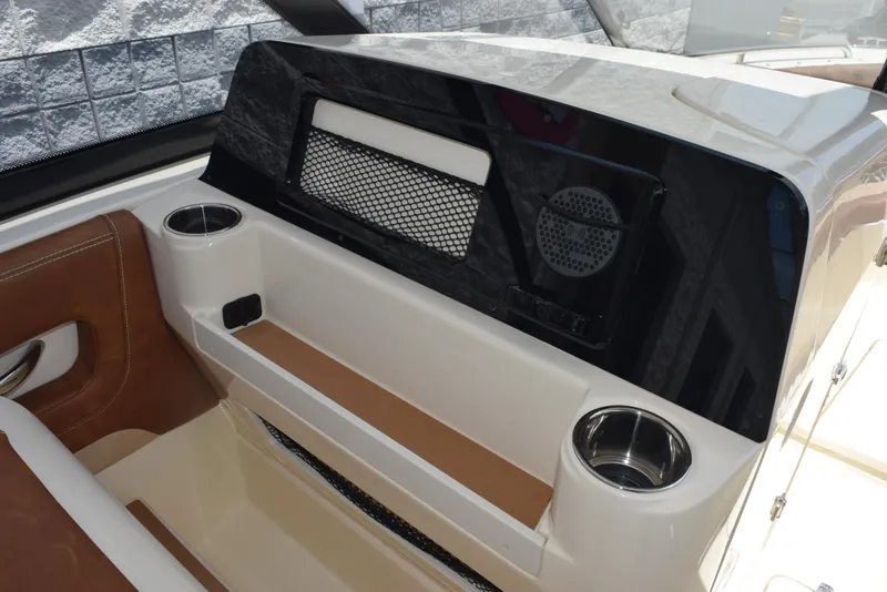 Slide: The Image of 2023 Scout 277 Dorado boat interior with cup holders and speaker system. - 22