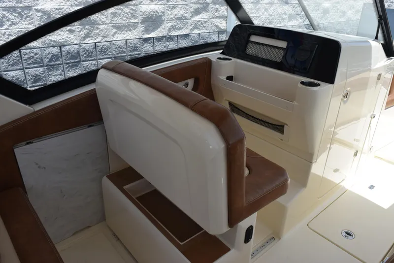 Slide: The Image of 2023 Scout 277 Dorado boat interior with brown and white seating and dashboard. - 23