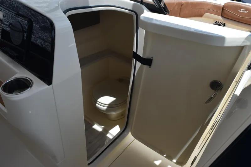 Slide: The Image of 2023 Scout 277 Dorado boat interior with open door revealing compact restroom. - 26