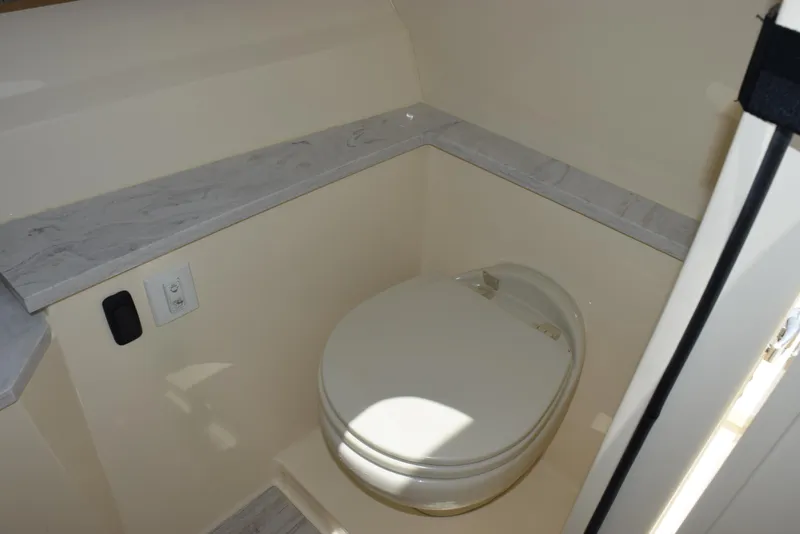 Slide: The Image of 2023 Scout 277 Dorado boat interior with compact marine toilet. - 27