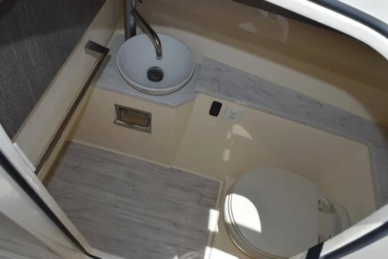 Slide: The Image of 2023 Scout 277 Dorado boat interior with sink and toilet in compact bathroom. - 28