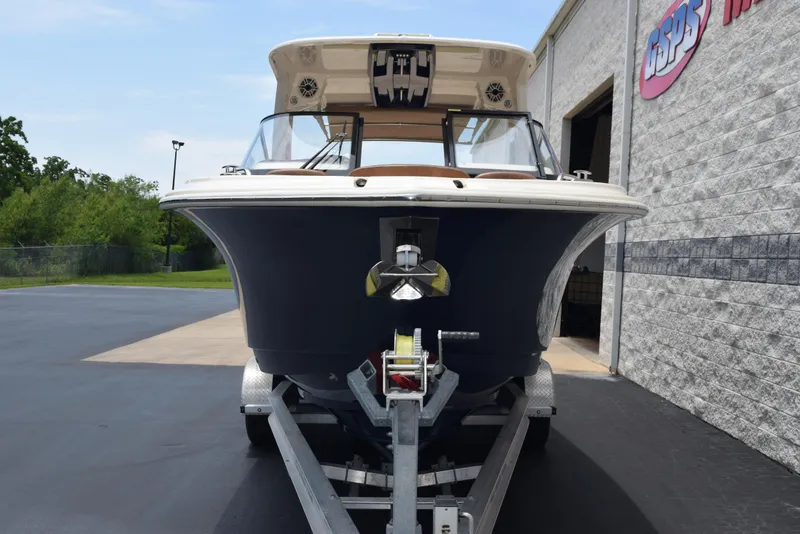 Slide: The Image of 2023 Scout 277 Dorado boat on trailer, parked outside a building. - 3