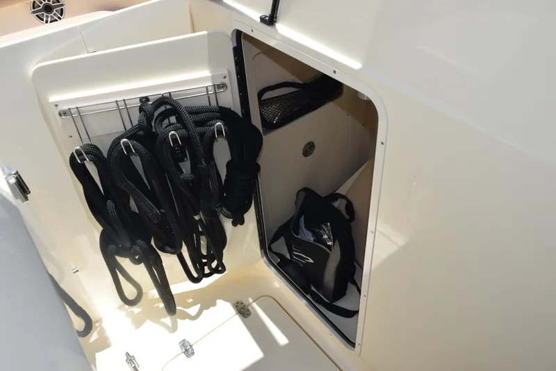 Slide: The Image of 2023 Scout 277 Dorado storage compartment with organized gear and equipment. - 30