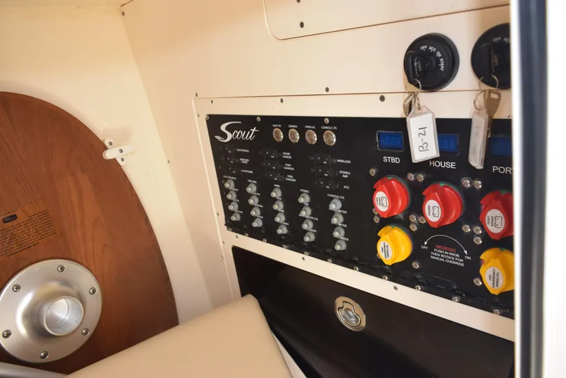 Slide: The Image of Control panel of 2023 Scout 277 Dorado boat with switches and gauges. - 32