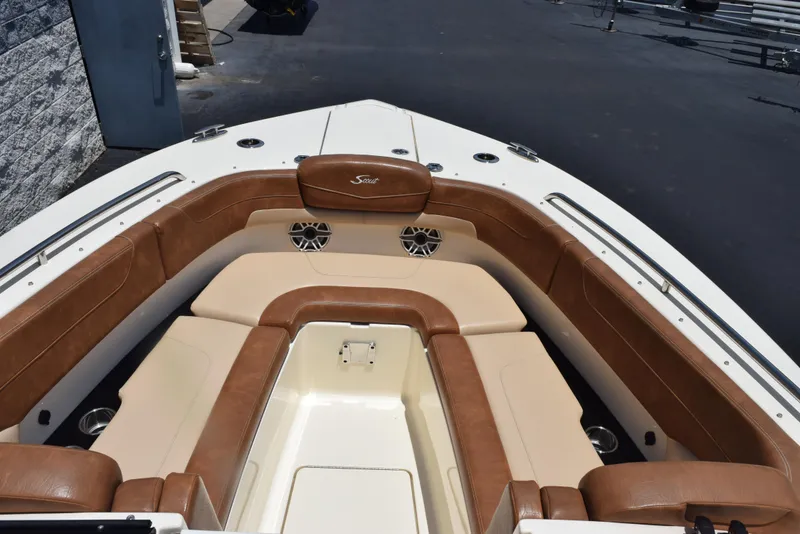 Slide: The Image of 2023 Scout 277 Dorado boat interior with brown leather seating and cup holders. - 36