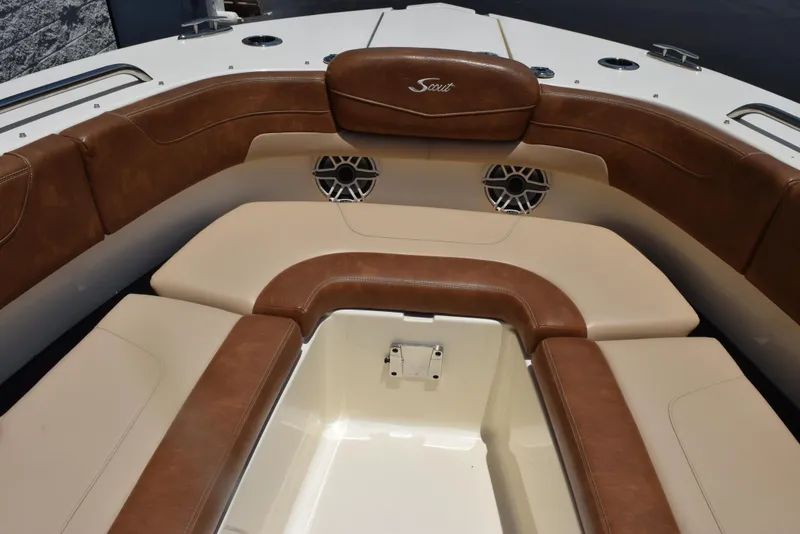 Slide: The Image of 2023 Scout 277 Dorado boat interior with brown leather seating and speaker system. - 39