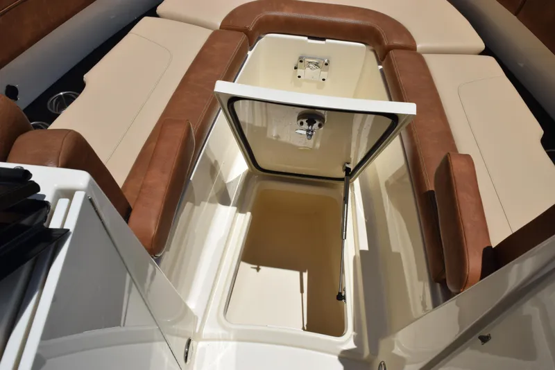 Slide: The Image of 2023 Scout 277 Dorado boat interior with open storage compartment and cushioned seating. - 41