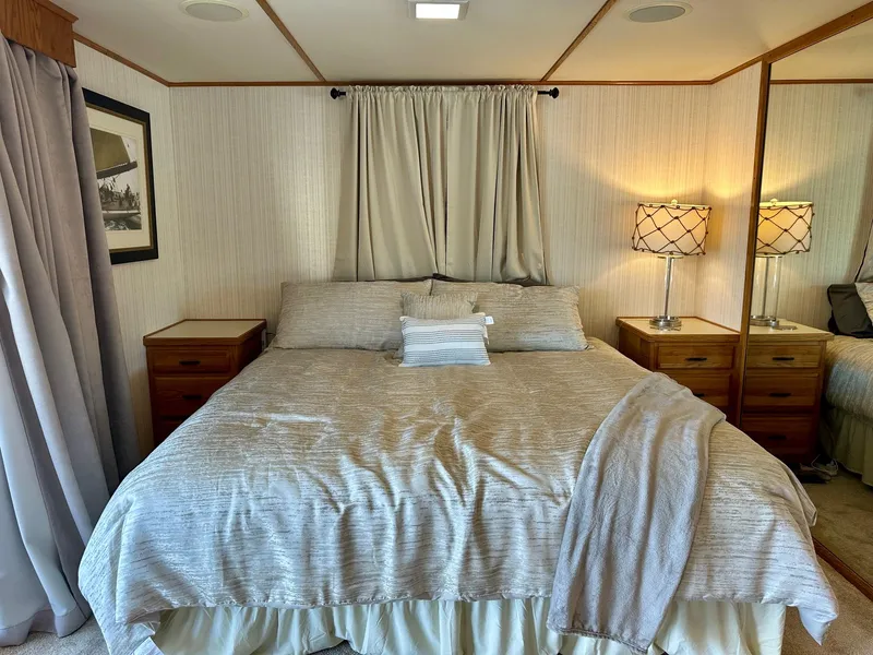 Slide: The Image of Cozy bedroom with neutral decor in a 1995 Lazy Days 16x75 houseboat. - 10