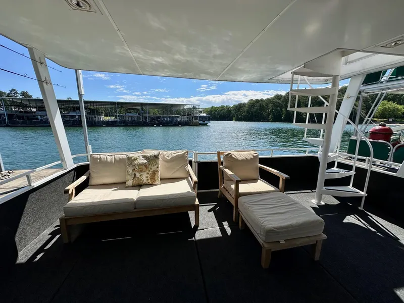 Slide: The Image of Spacious deck of 1995 Lazy Days 16x75 houseboat with comfortable seating and scenic lake view. - 16