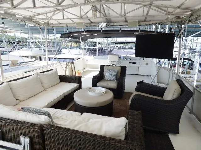 Slide: The Image of Spacious deck of 1995 Lazy Days 16x75 houseboat with comfortable seating and TV. - 17
