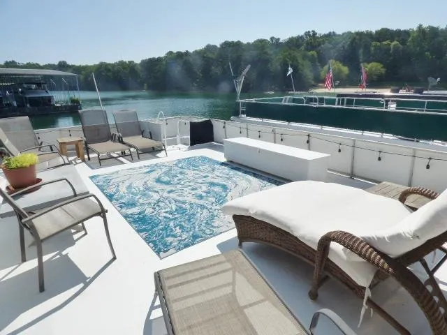 Slide: The Image of Luxurious 1995 Lazy Days 16x75 houseboat with sun deck and hot tub on a serene lake. - 19