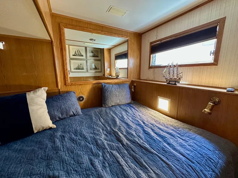 Slide: The Image of Cozy bedroom in 1995 Lazy Days 16x75 houseboat with nautical decor and blue bedding. - 7