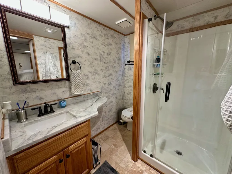 Slide: The Image of Bathroom in 1995 Lazy Days 16x75 model with shower and vanity. - 9