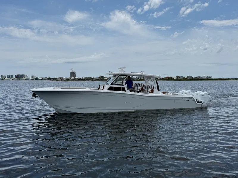 The Image of 2026 Caymas 44 CT boat on calm water under a partly cloudy sky. - 1
