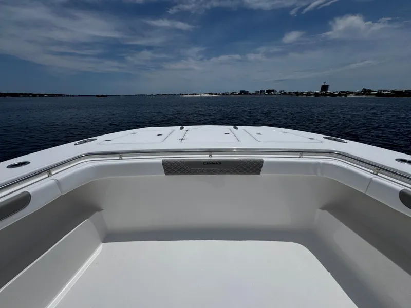 Slide: The Image of 2026 Caymas 44 CT boat deck with ocean view under a partly cloudy sky. - 19